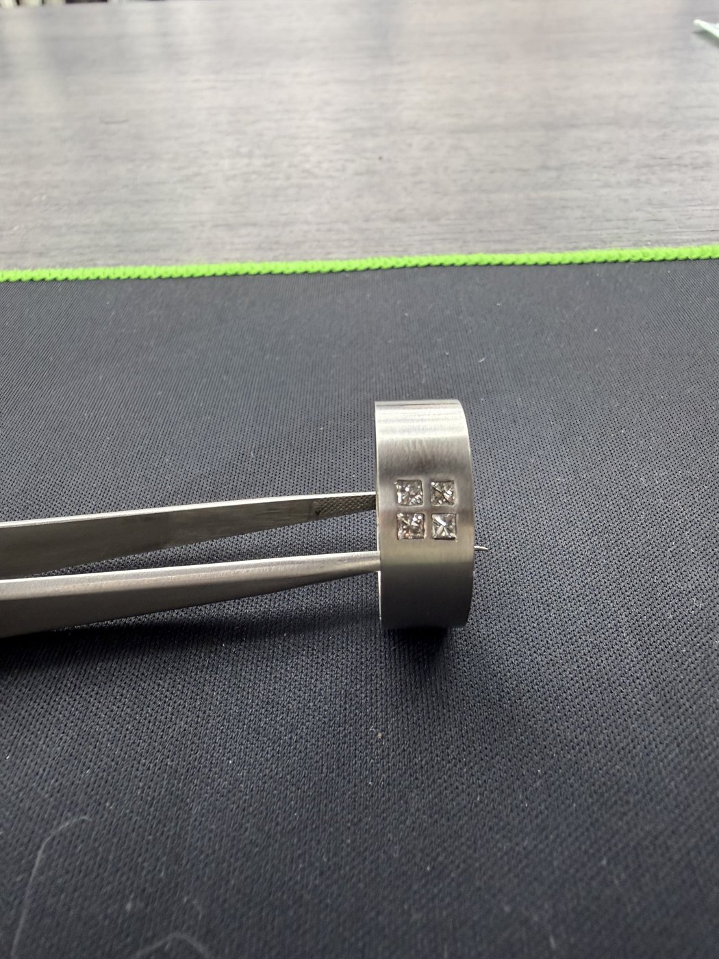 Engraved band held with a tool on a counter