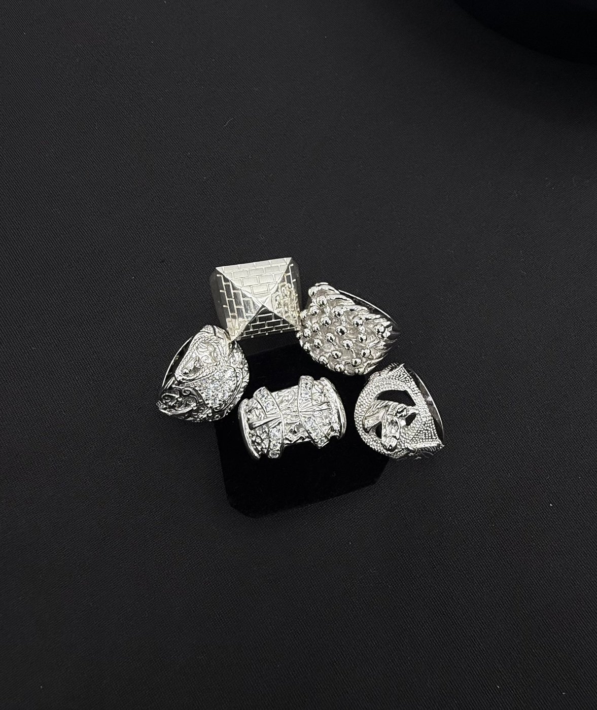 Statement rings arranged on a dark surface