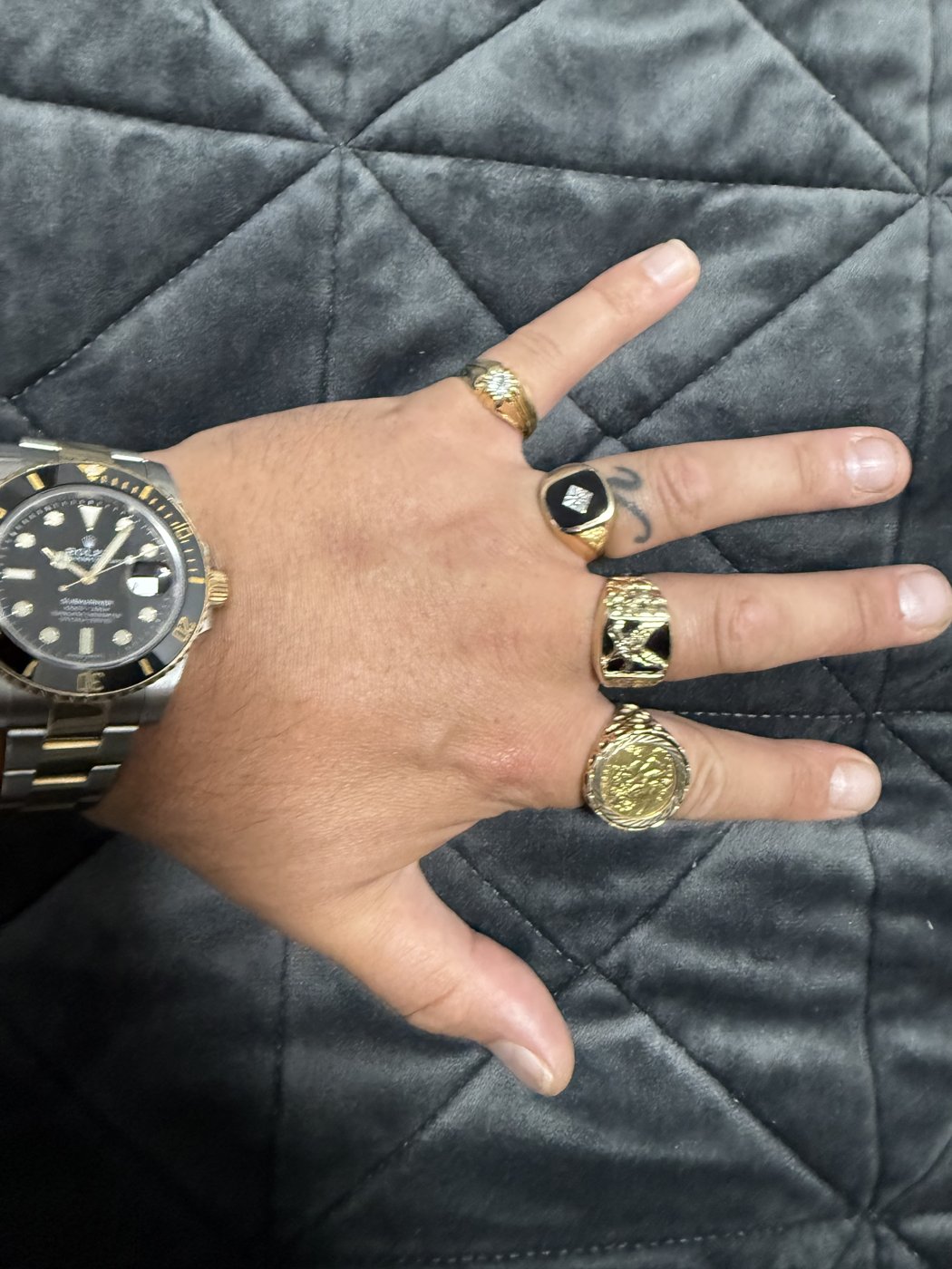 Mixed gold rings worn on a hand