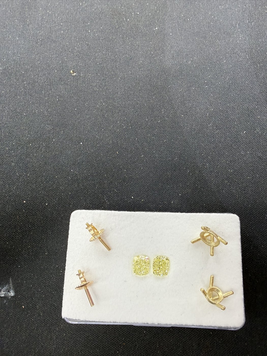 Earrings arranged on a white display pad