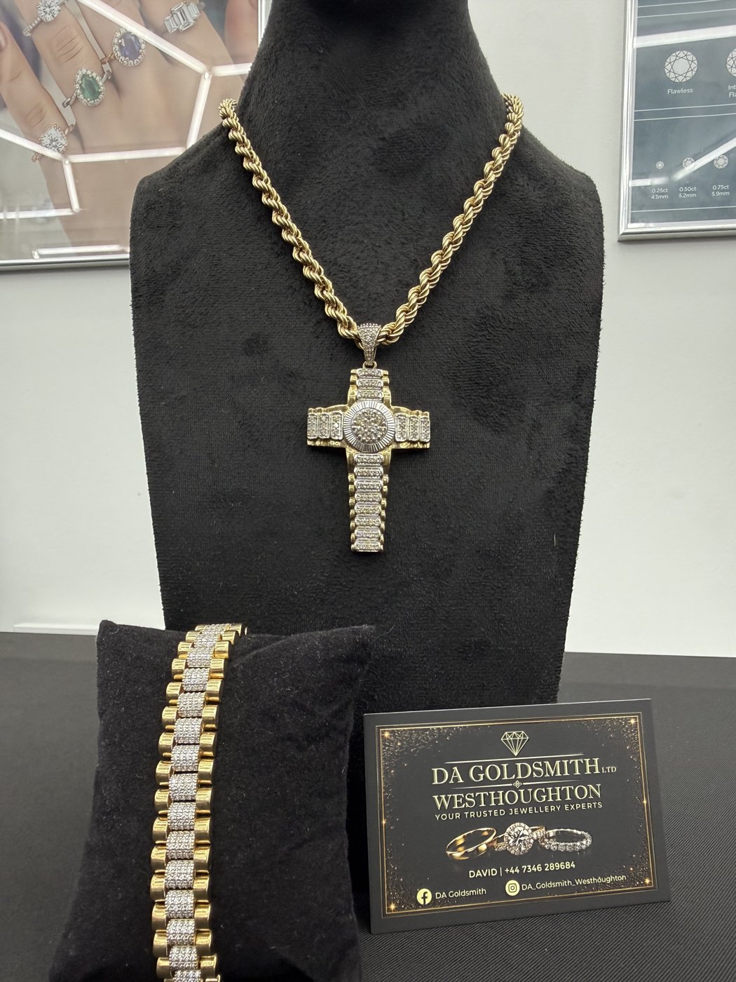 Cross pendant necklace and bracelet on black displays