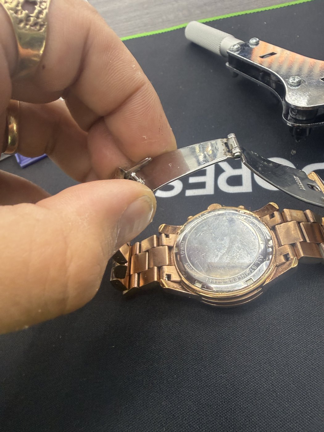 Watch case held open on a work surface
