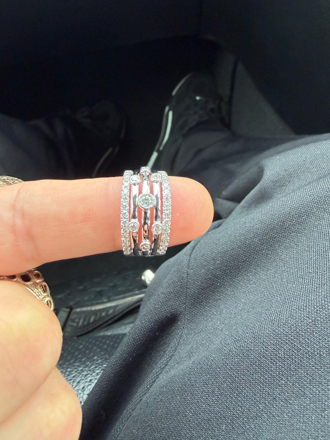 Custom-made diamond ring worn on a finger